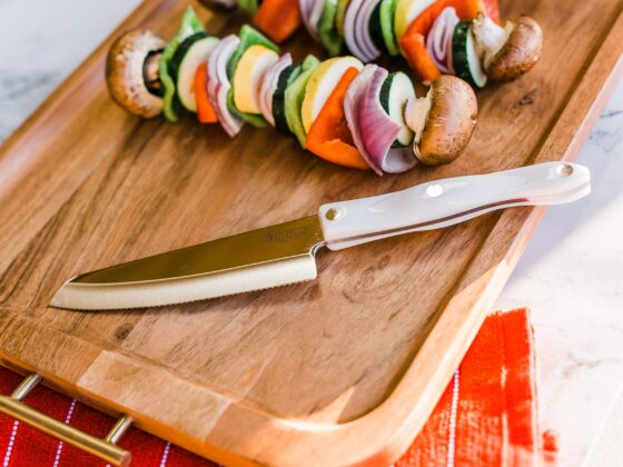 Cutco hardy slicer on cutting board with kebabs